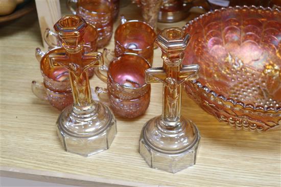A pair of Carnival glass crucifix candlesticks and a collection of other marigold Carnival glass,